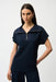 Woman wearing a navy blue zip front short sleeve top from Joseph Ribkoff