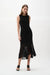 Woman wearing knit dress with chiffon flounce hem and sleeveless elegant silhouette