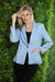 Woman wearing Joseph Ribkoff bouclé blazer for elegant office outfit
