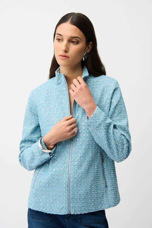 Woman wearing a sky blue sequin denim jacket with stand collar and zip front, styled for parties, concerts, travel, or glamorous casual layering.