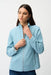 Woman wearing a sky blue sequin denim jacket with stand collar and zip front, styled for parties, concerts, travel, or glamorous casual layering.