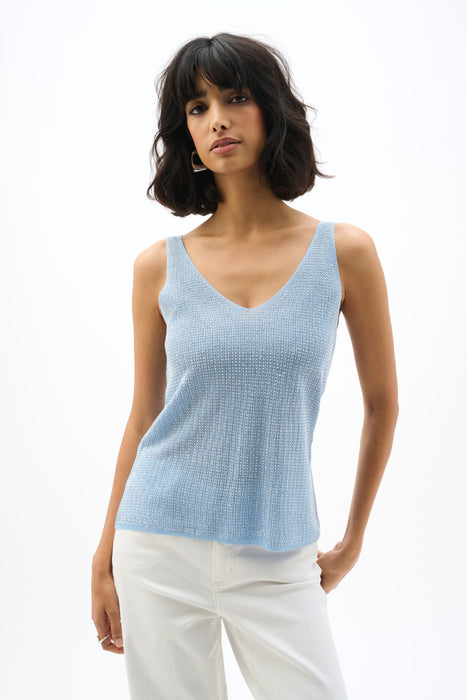Woman wearing a metallic ribbed knit camisole with rhinestone details and V-neckline, styled for evening events, cocktail parties, date nights, or chic layered outfits.