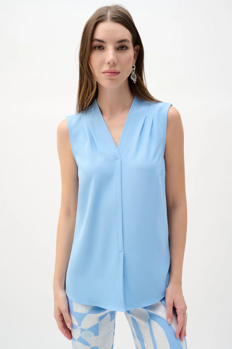 Woman wearing Joseph Ribkoff straight pleated tunic for elegant office outfit