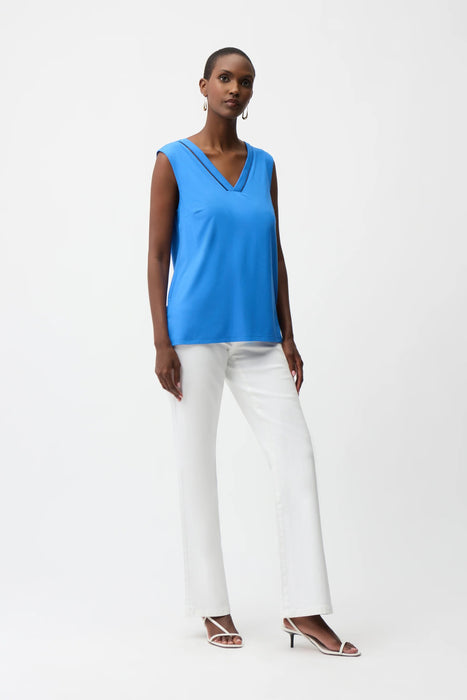 Woman wearing Joseph Ribkoff sleeveless straight top with sheer trim, featuring a V-neckline, relaxed fit, and elegant minimalist design for modern chic styling.
