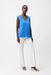 Woman wearing Joseph Ribkoff sleeveless straight top with sheer trim, featuring a V-neckline, relaxed fit, and elegant minimalist design for modern chic styling.