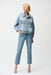 Woman wearing Joseph Ribkoff slim leg jeans with pearls and studs, featuring embellished light-wash denim, cropped length, and a flattering modern fit.