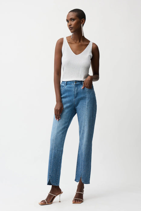Woman wearing Joseph Ribkoff blue slim leg jeans with rhinestone detail, featuring a flattering stretch fit, mid-rise waist, and subtle sparkle for chic modern styling.