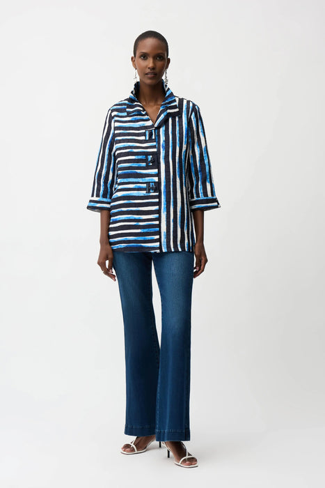 Woman wearing Joseph Ribkoff stripe trapeze jacket with shirred collar, featuring bold vertical stripes, a relaxed flowy fit, and stylish three-quarter sleeves.