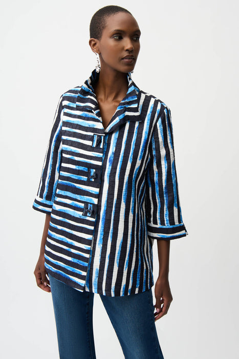 Woman wearing Joseph Ribkoff stripe trapeze jacket with shirred collar, featuring bold vertical stripes, a relaxed flowy fit, and stylish three-quarter sleeves.