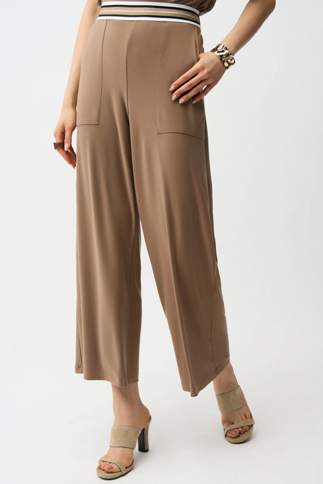 Woman in cropped stretch trousers with striped elastic waistband