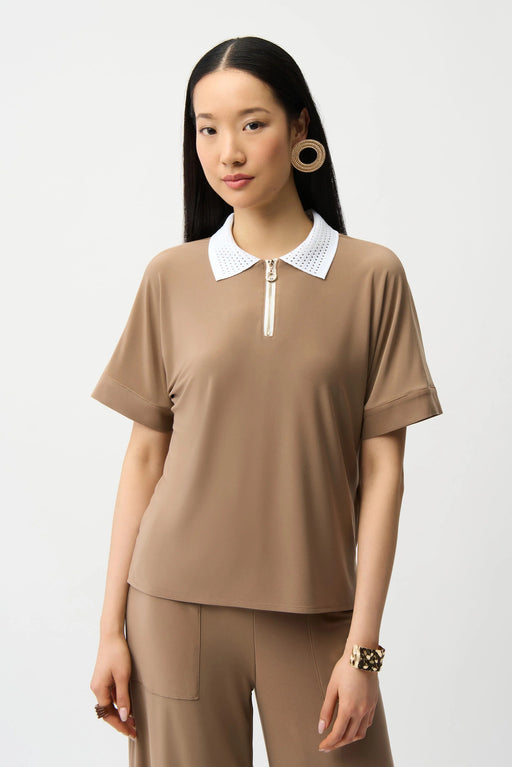 Woman wearing a silky knit boxy polo top with contrast white collar and gold zipper, styled for office wear, travel, or modern casual chic outfits.