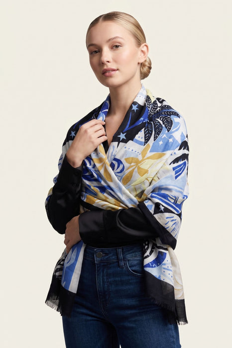 Woman wearing a colorful scarf with tropical print and fringe edges from Joseph Ribkoff