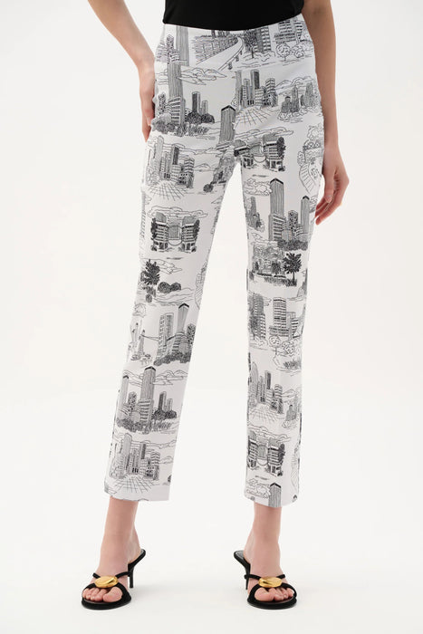 Woman wearing a white straight crop pants with black cityscape print and pull on waistband from Joseph Ribkoff