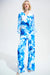 Woman wearing a white wide leg pants with blue floral print from Joseph Ribkoff