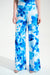 Woman wearing a white wide leg pants with blue floral print from Joseph Ribkoff