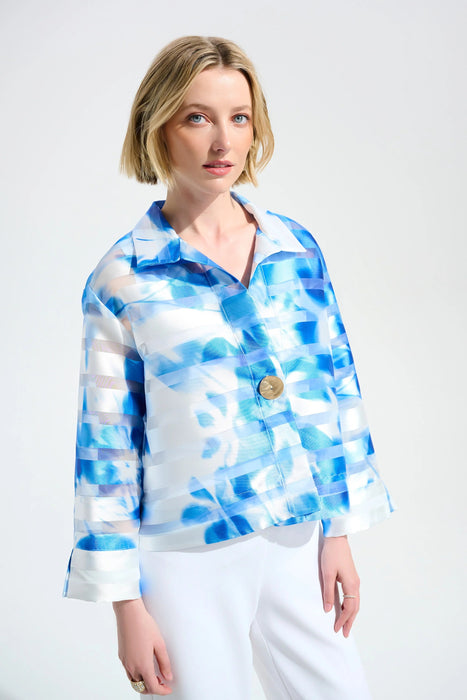 Woman wearing a blue and white jacket with alternating floral print and shadow stripes from Joseph Ribkoff