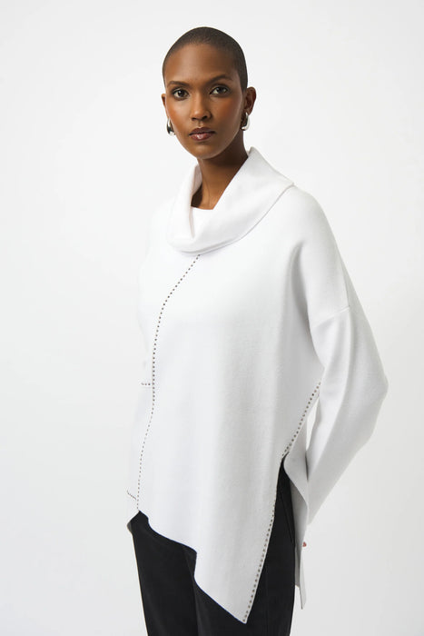 Woman wearing a solid color white sweater knit top with cowl neck and asymmetric hem