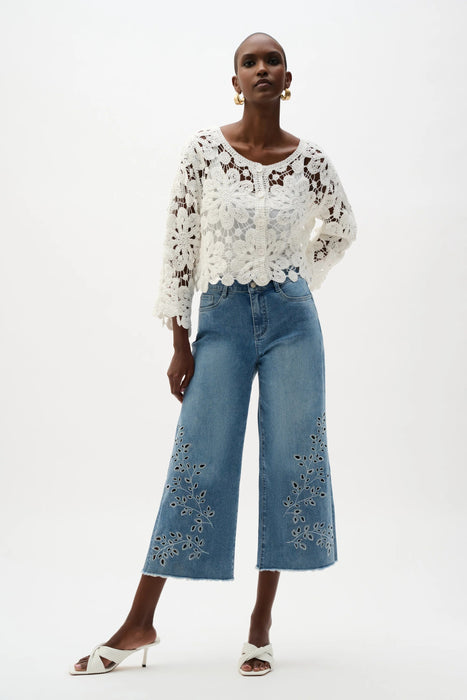 Woman wearing Joseph Ribkoff vanilla crochet boxy cardigan with floral lace design