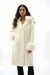 Woman wearing a white coat with detachable faux fur trim and long sleeves from Joseph Ribkoff