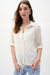Woman wearing Joseph Ribkoff vanilla drawstring hem cocoon blouse styled for office chic, casual outings, travel days, and modern elegant everyday wear.