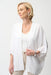 Woman wearing a white open front cover-up with rhinestone embellishments and 3/4 sleeves from Joseph Ribkoff