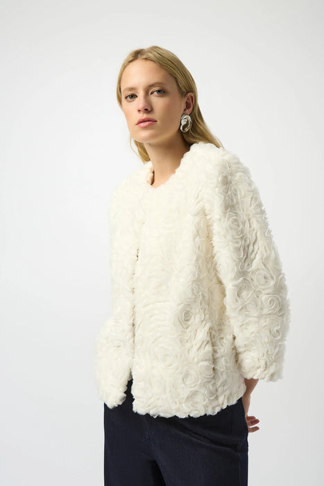 Woman wearing a white rosette textured jacket with 3/4 sleeves