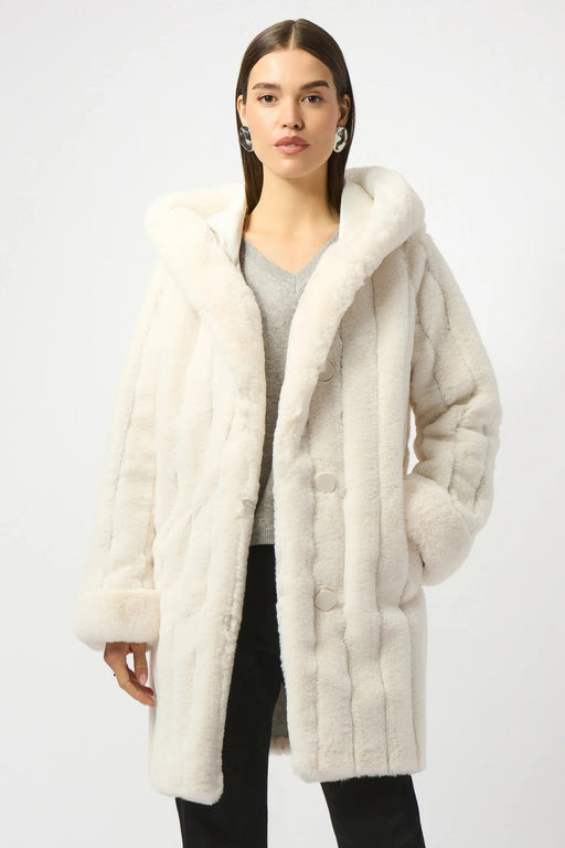 Woman wearing a white reversible hooded quilted faux fur coat