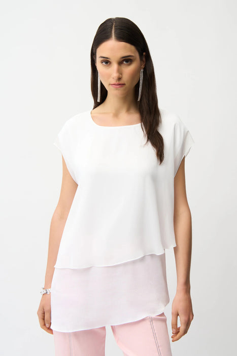 Woman wearing a white layered tunic top with asymmetric hem and short sleeves from Joseph Ribkoff