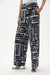 Woman modeling full length wide leg abstract print pants
