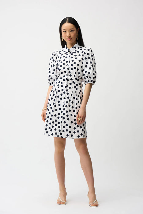 Woman wearing Joseph Ribkoff dot print A-line shirt dress with puff sleeves and button-down front, showcasing a feminine and modern silhouette.