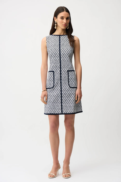 Woman wearing sleeveless A-line dress with geometric pattern and contrast trim from Joseph Ribkoff