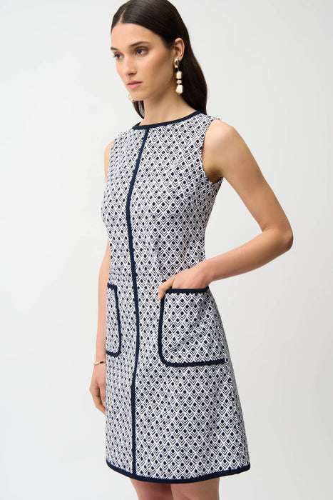 Woman wearing sleeveless A-line dress with geometric pattern and front pockets from Joseph Ribkoff