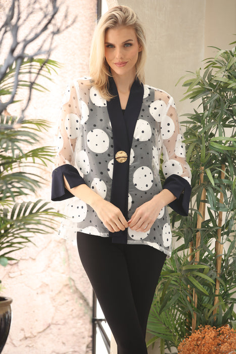 Woman wearing a white polka dots patterned jacket with one-button closure and 3/4 sleeves from Joseph Ribkoff
