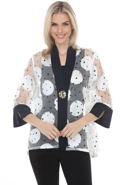 Woman wearing a white polka dots patterned jacket with one-button closure and 3/4 sleeves from Joseph Ribkoff