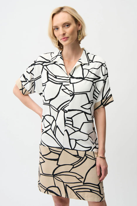 Woman wearing an abstract-printed shirt dress with color block hem and short sleeves from Joseph Ribkoff