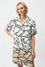 Woman wearing an abstract-printed shirt dress with color block hem and short sleeves from Joseph Ribkoff