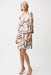 Woman wearing Joseph Ribkoff abstract print trapeze dress with gold neckline detail, featuring a flowy silhouette and elegant modern style.