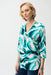 Woman wearing an abstract-patterned tunic top with zip v-neck and 3/4 sleeves from Joseph Ribkoff