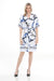 Woman wearing a white printed knee-length dress with abstract and stripes pattern from Joseph Ribkoff