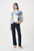 Woman wearing Joseph Ribkoff vanilla multi tropical print cowl neck boxy top with slim leg jeans featuring pearls and studs, embellished light-wash denim, cropped length, and a flattering modern fit.