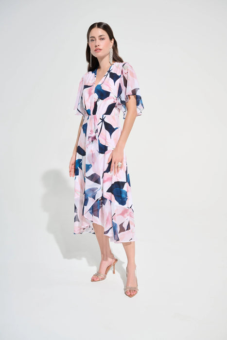 Woman wearing a vanilla multi floral print fit and flare midi dress with flutter sleeves, styled for an elegant and feminine occasion look