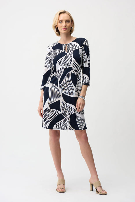 Woman wearing blue and white geometric stripes patterned shift dress with 3/4 sleeves from Joseph Ribkoff