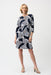 Woman wearing blue and white geometric stripes patterned shift dress with 3/4 sleeves from Joseph Ribkoff