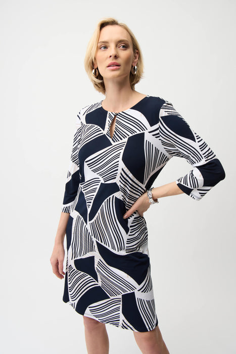 Woman wearing blue and white geometric stripes patterned shift dress with 3/4 sleeves from Joseph Ribkoff