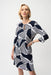 Woman wearing blue and white geometric stripes patterned shift dress with 3/4 sleeves from Joseph Ribkoff