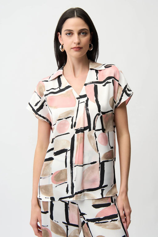 Woman wearing a short-sleeve blouse with geometric pattern and collared v-neck from Joseph Ribkoff