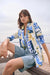 Woman wearing Joseph Ribkoff tropical print blazer for stylish office outfit