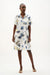 Woman wearing Joseph Ribkoff tropical print A-line dress styled for summer outings, resort wear, vacations, and casual chic daytime looks.