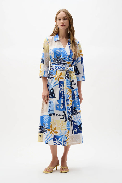 Woman wearing a Joseph Ribkoff vanilla multi tropical print A-line wrap midi dress with tie waist and relaxed sleeves, styled for a chic summer look