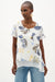 Woman wearing Joseph Ribkoff vanilla multi tropical print trapeze tunic with short sleeves, a flowy asymmetrical hem, and a relaxed lightweight fit for summer styling.